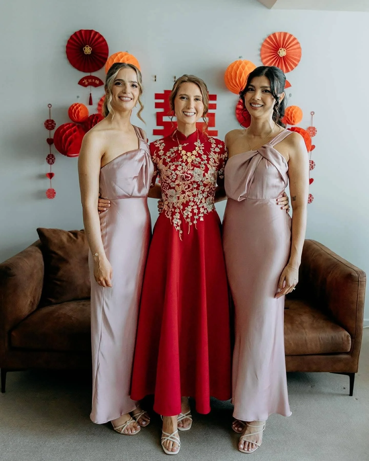 Bride in red Chinese wedding gown with bridesmaids, featuring bridal and bridesmaid dress alterations in Ringwood.
