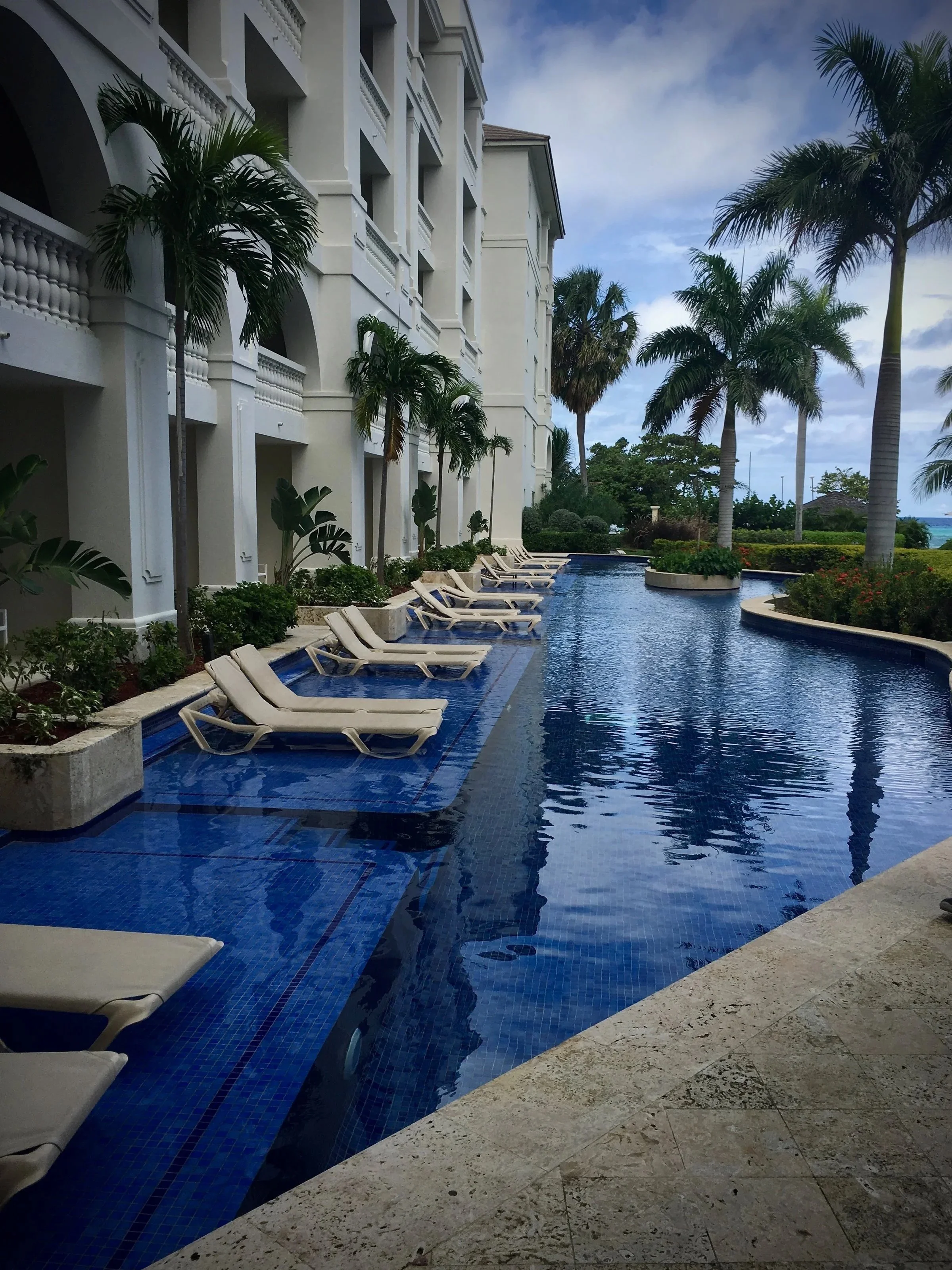 Resort pool and oceanfront grounds at a luxury all-inclusive in Montego Bay, Jamaica — Miller Travel Group Caribbean travel