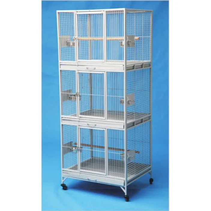 Multi-level white metal birdcage with mesh sides and sliding trays, on casters, against a blue background.