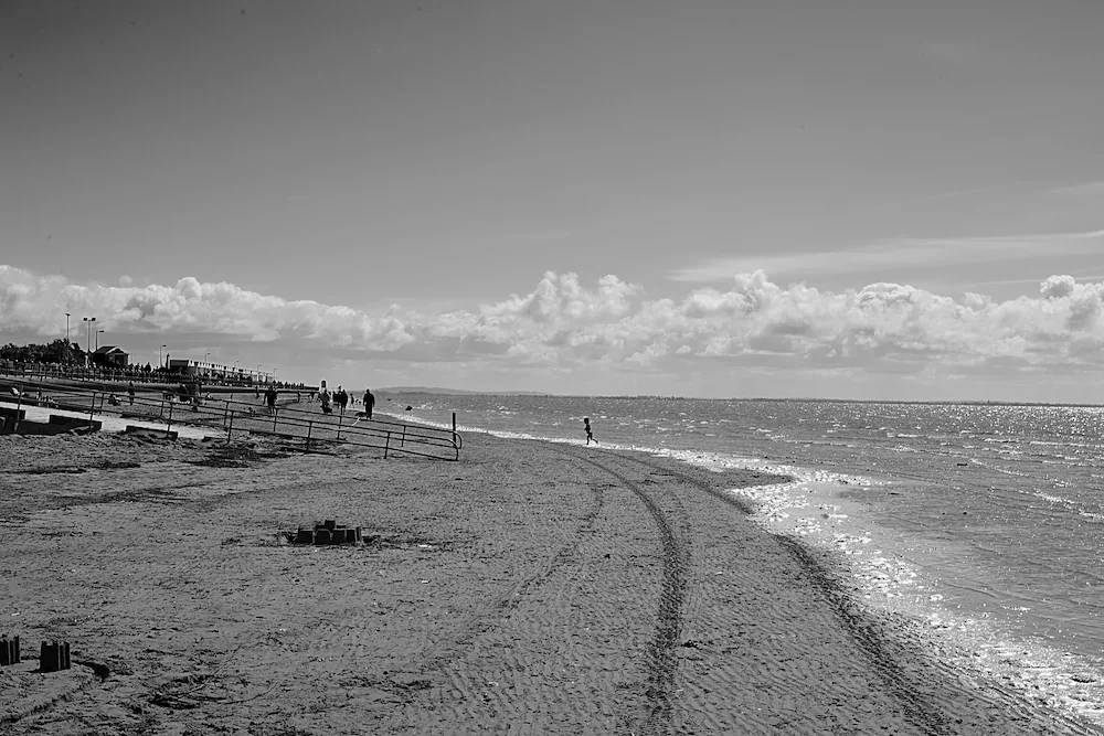 northwest-coast-vast-beach-tire-tracks-clouds-lancashire-bw.webp