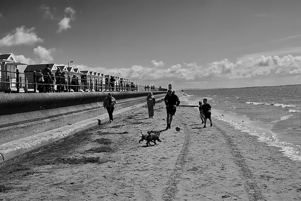 northwest-coast man playing football beach huts lancashire ine art photography by ManChingKC