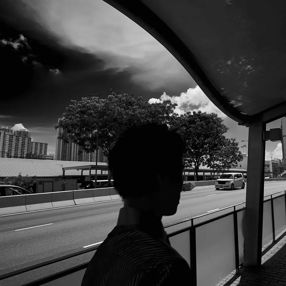 black-and-white-photo-of-a-man-silhouette-against-a-road.webp