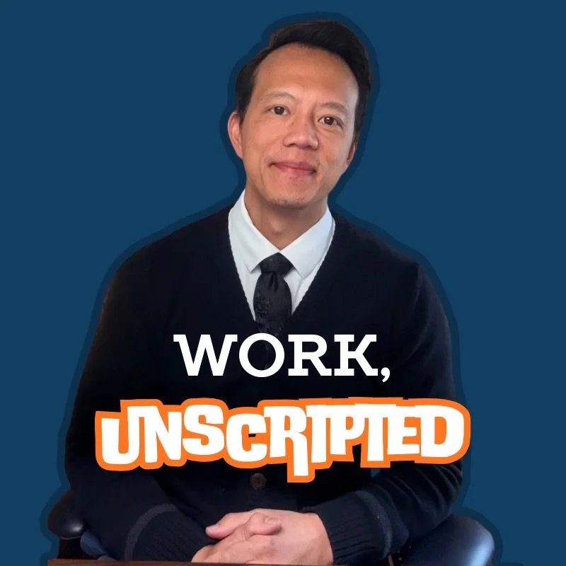 A man in a black sweater, white shirt, and black tie sitting with hands clasped, smiling slightly against a blue background. Overlay text reads 'WORK, UNSCRIPTED'.