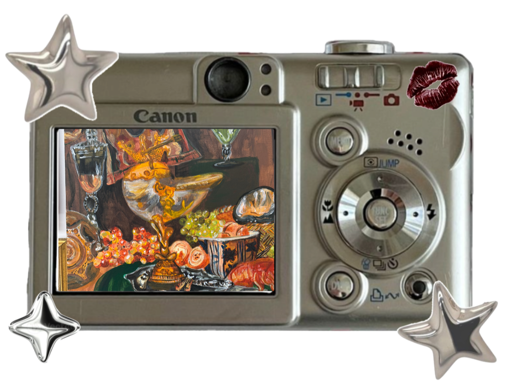 Digital camera with decorative stars and kiss mark stickers on its body, displaying a colorful still-life painting of fruit, flowers, and various objects on its screen.