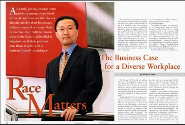 tear sheet magazine article of an asian man in glasses, a dark suit, and a patterned tie stands in front of a red and white background with text about business and workplace diversity.