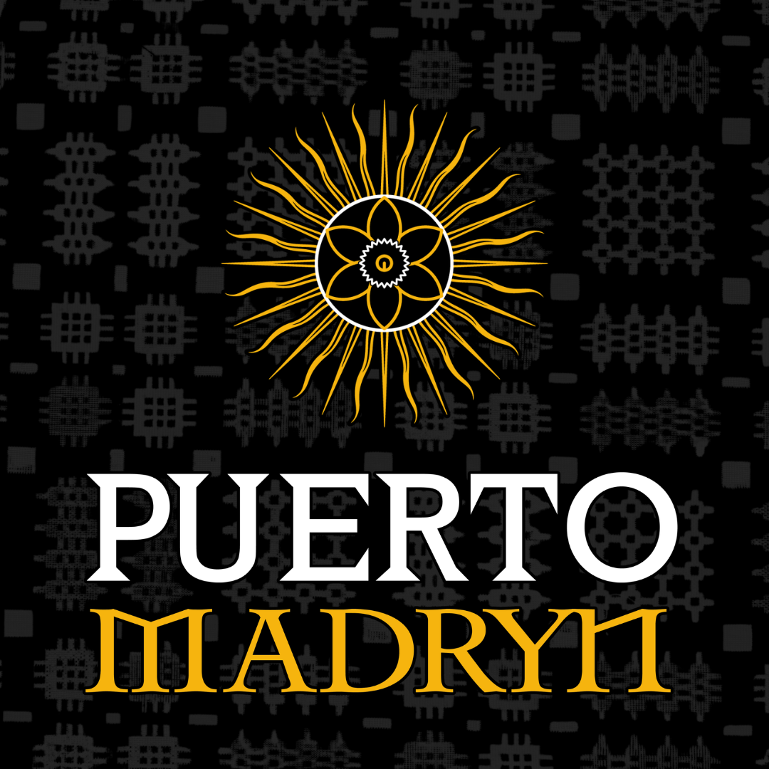 Design featuring a gold sun with radiating lines and a central floral pattern, set against a black background with traditional geometric motifs. Text reads 'Puerto Madryt' with 'Puerto' in white and 'Madryt' in gold.