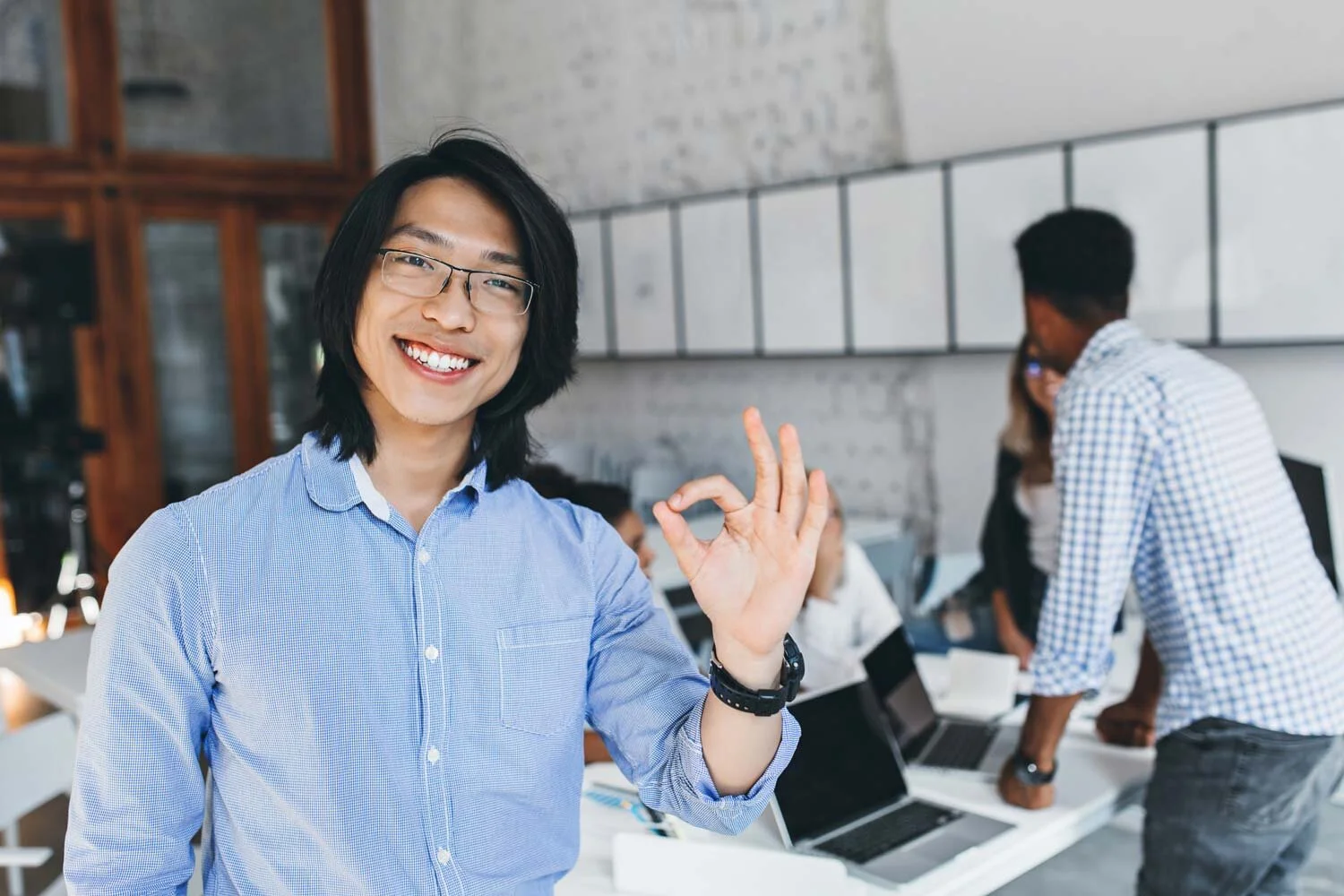pleased-asian-guy-classic-blue-t-shirt-posing-with-okay-sign-after-conference-with-colleagues-indoor-portrait-happy-chinese-entrepreneur-glasses-enjoying-good-day.jpg