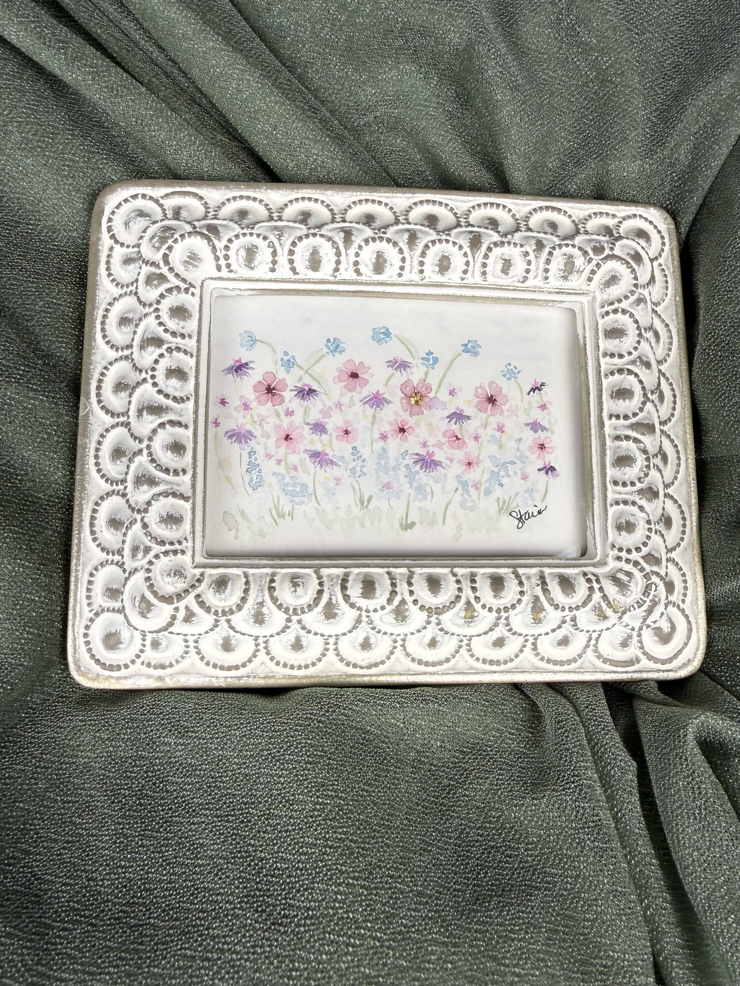 Meadow Secret watercolor painting of pink, purple and blue wildflowers with a citrine gemstone in an ornate white frame by Stacia Shane
