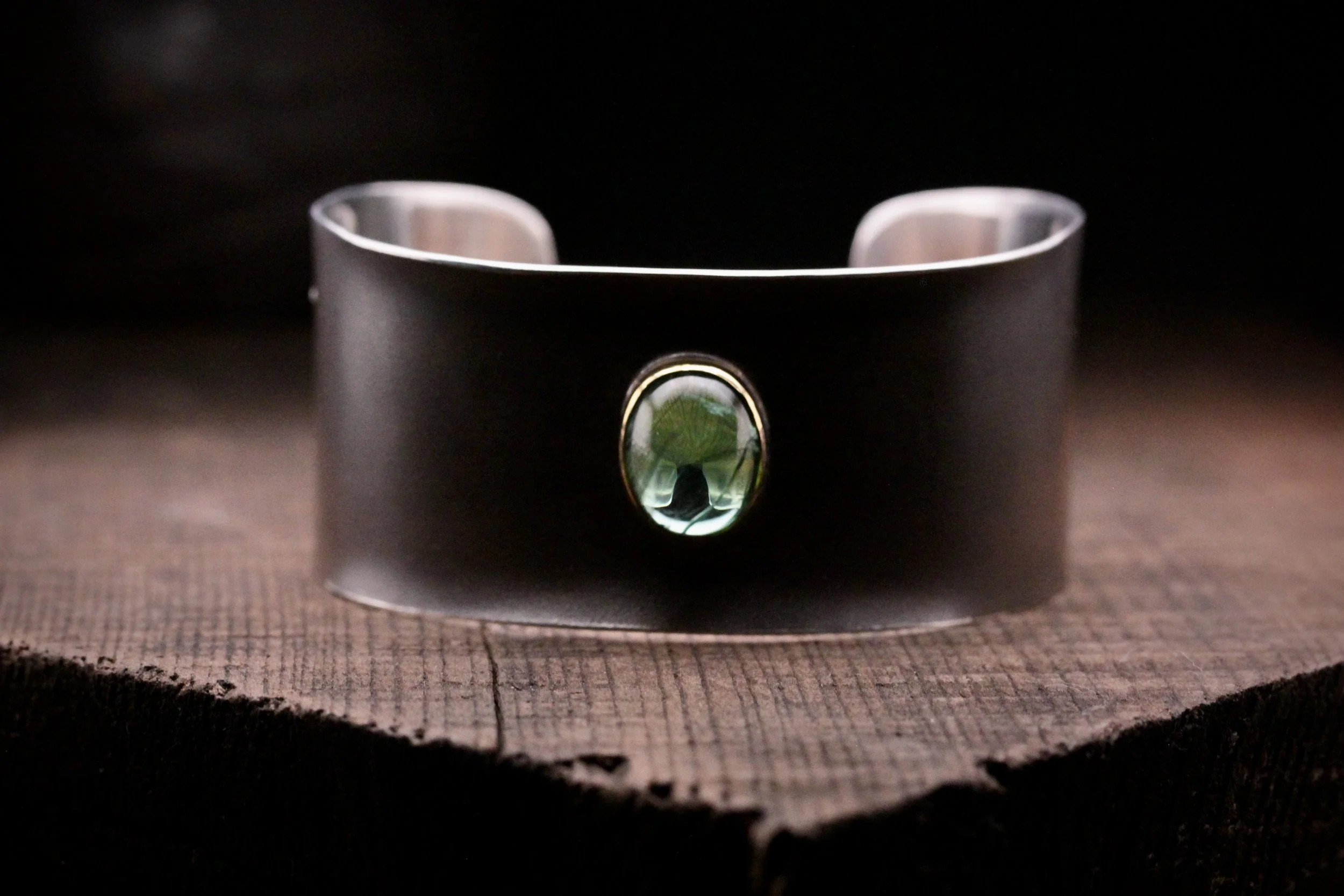 Carrie Armstrong Cuff with central green oval gemstone.