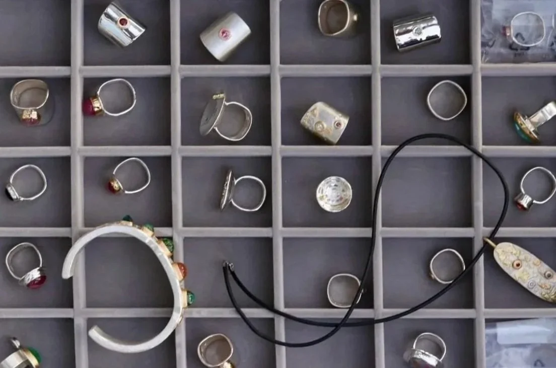 Jewelry display box with rings and a necklace.