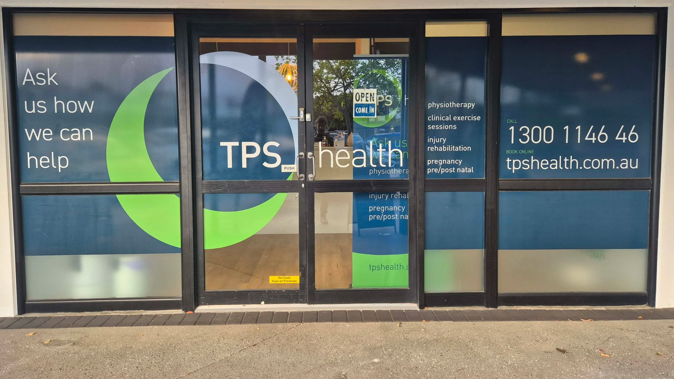 Exterior of TPS Bayside's Victoria Point physiotherapy clinic with blue windows and doors, displaying services including physiotherapy, clinical exercise sessions, injury rehabilitation, pregnancy, and pre/post natal care. 