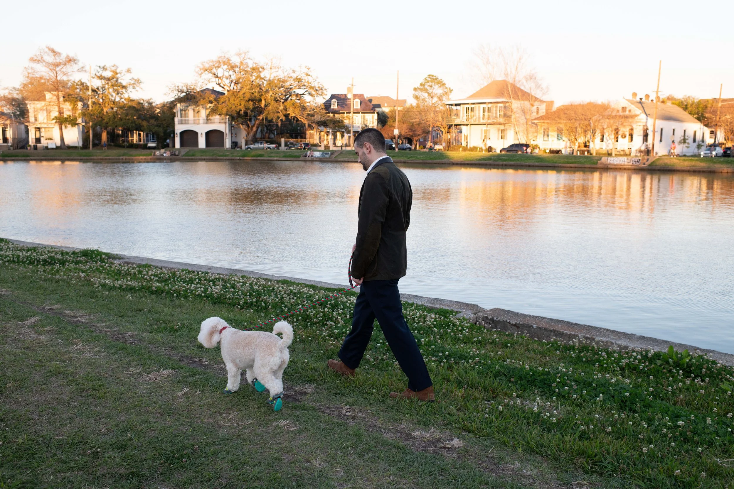 Image of Dr. Mauch walking a dog next to a body of water