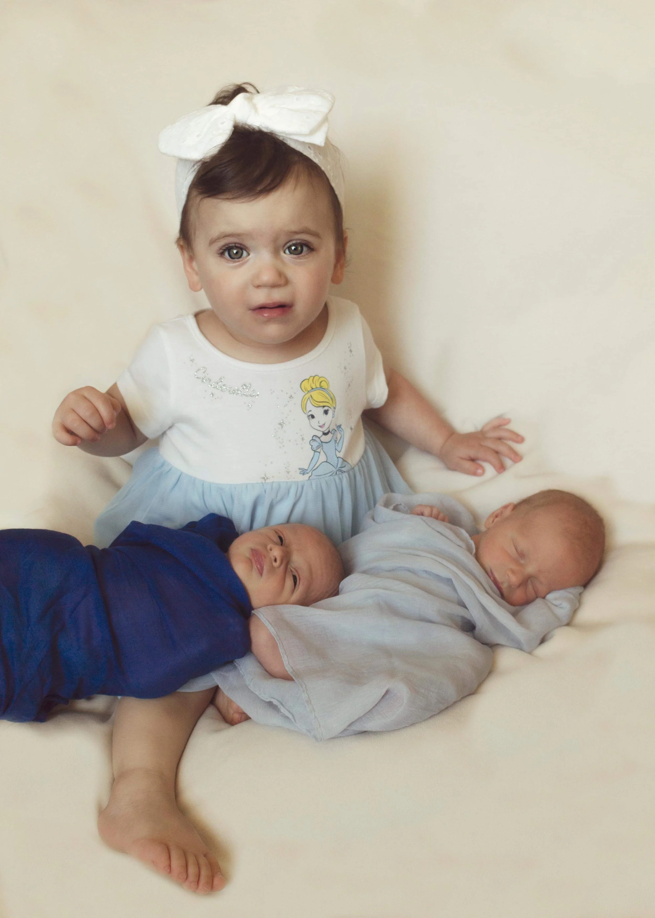 One year old sister with her newborn twin brothers.