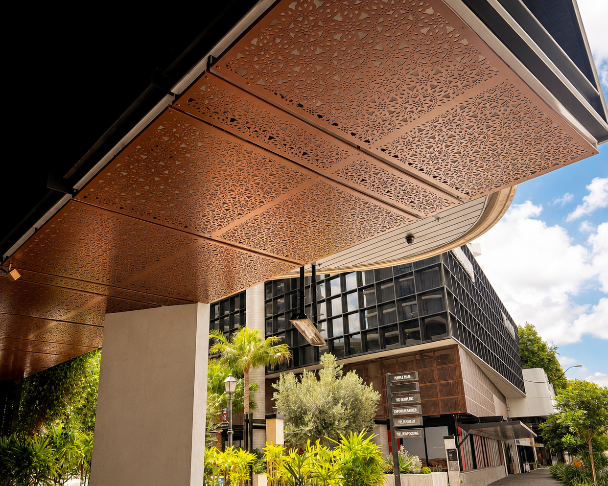Decorative laser cut screens for canopy shade . Outdoor commercial screens for soffit. Lace design in custom powder coat colour. Project designed by Deborah VanDieren. Architectural metal work. Forge Architectural Co.