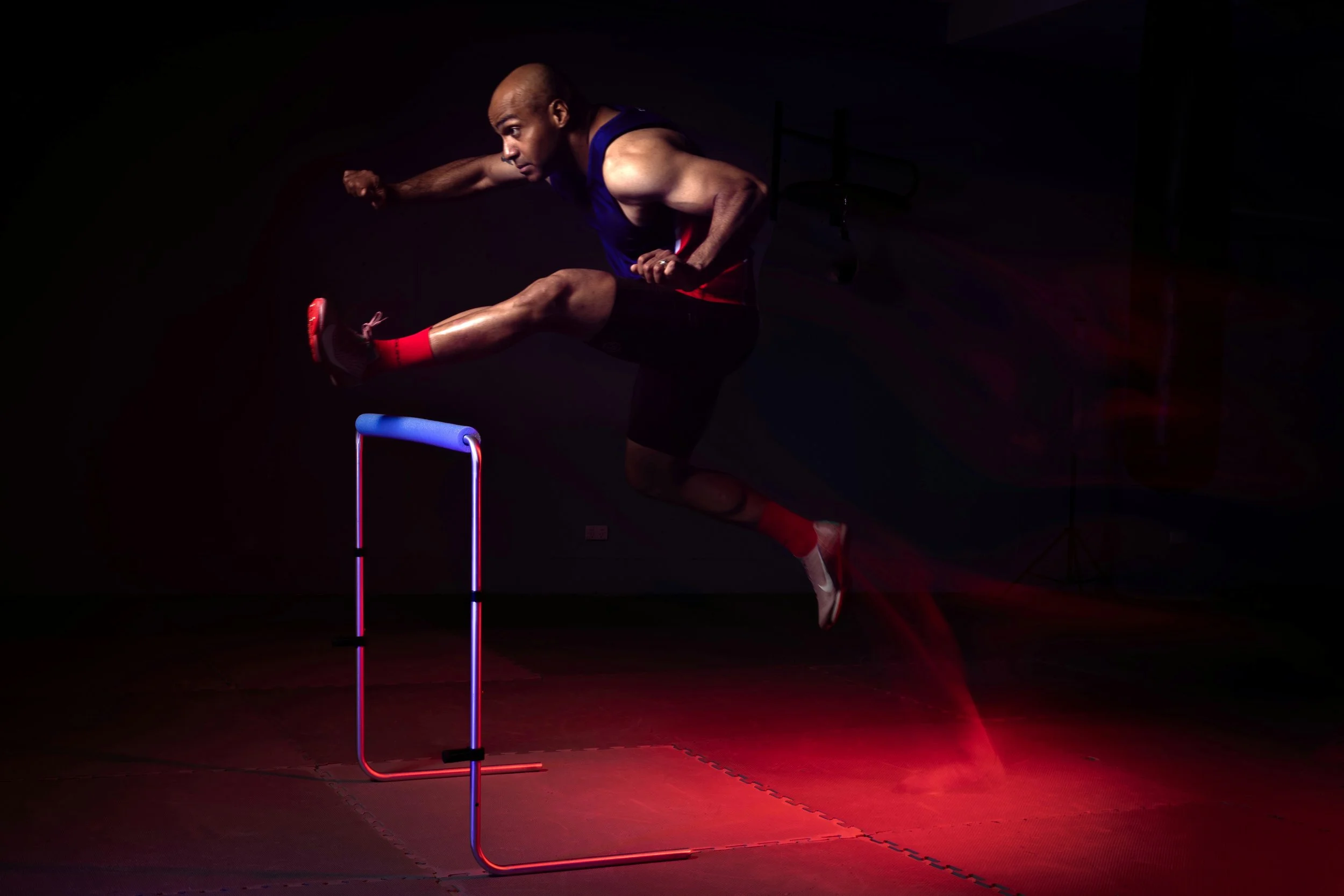 Nunu Campos, head coach of ASIKU, hurdling at a photoshoot