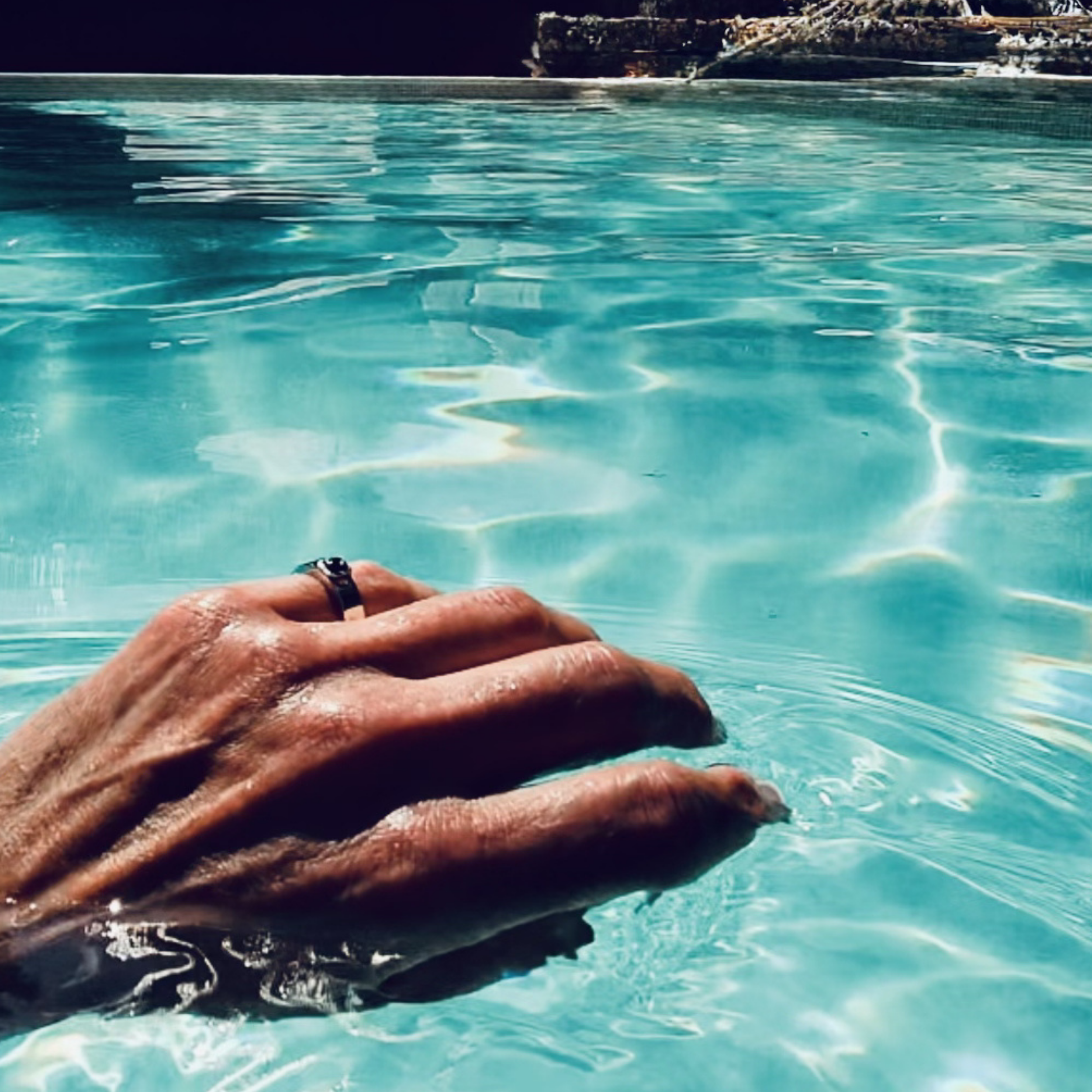 ØRIGEN men’s pinky ring with natural Fancy Deep Brown Yellow diamond worn by the pool