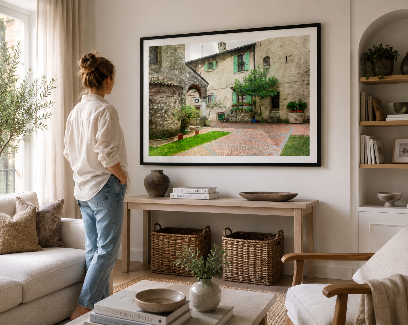 Quiet Tuscan courtyard with stone walls, potted plants and historic architecture.