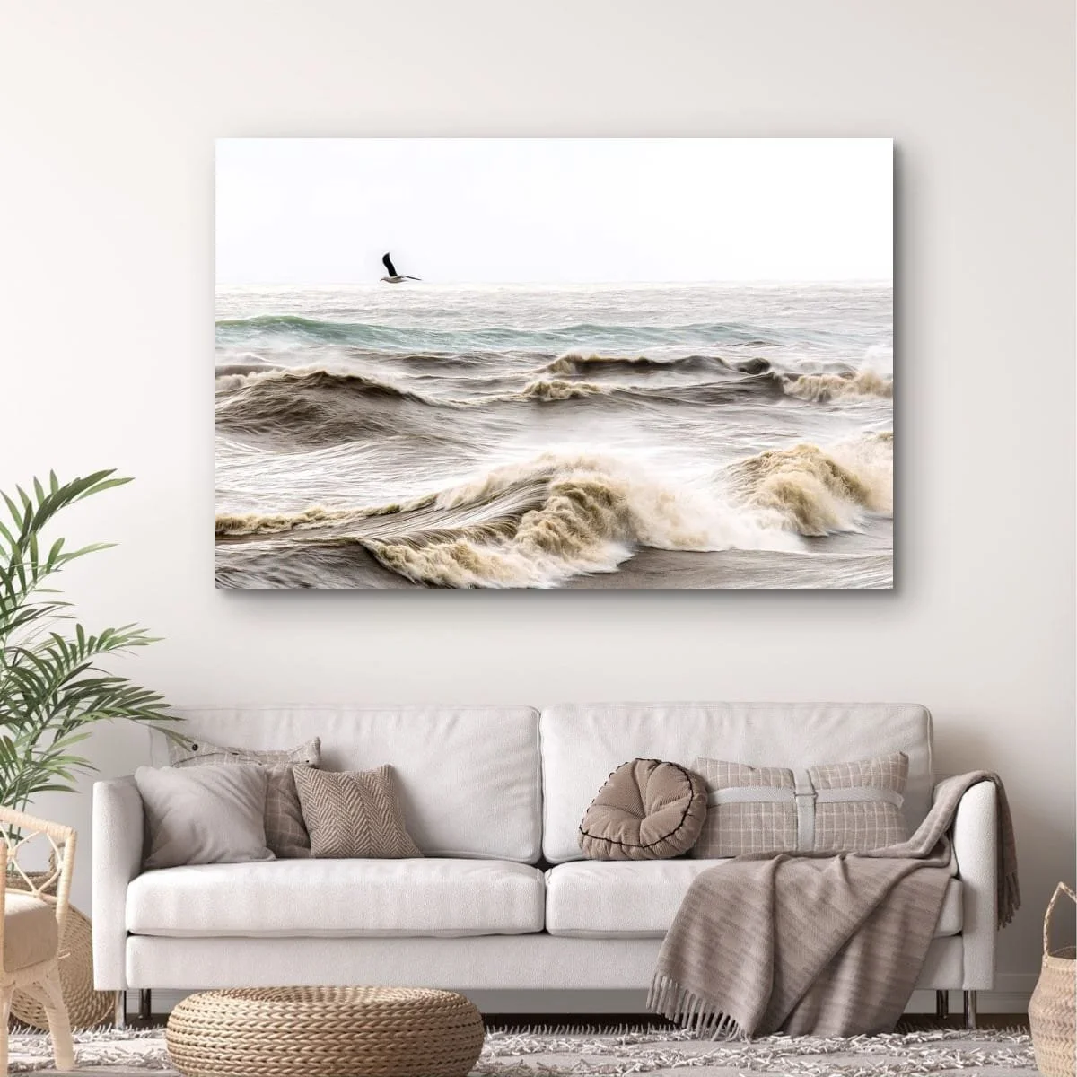 Seabird flying above rough ocean waves.