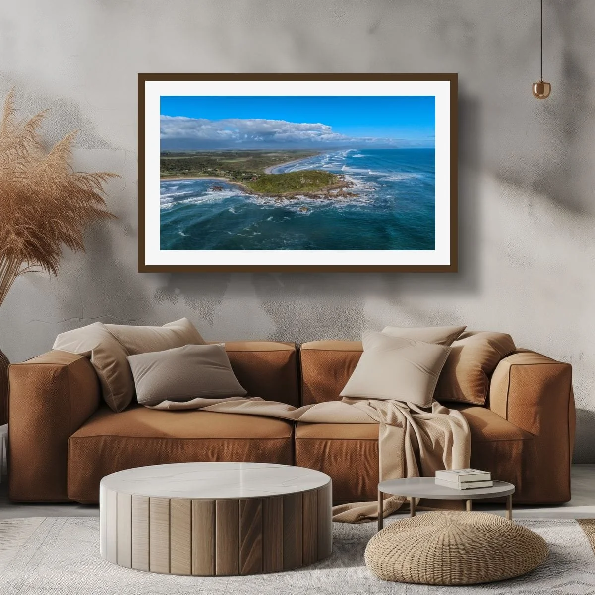 Aerial view of rugged West Coast shoreline and rolling ocean waves.