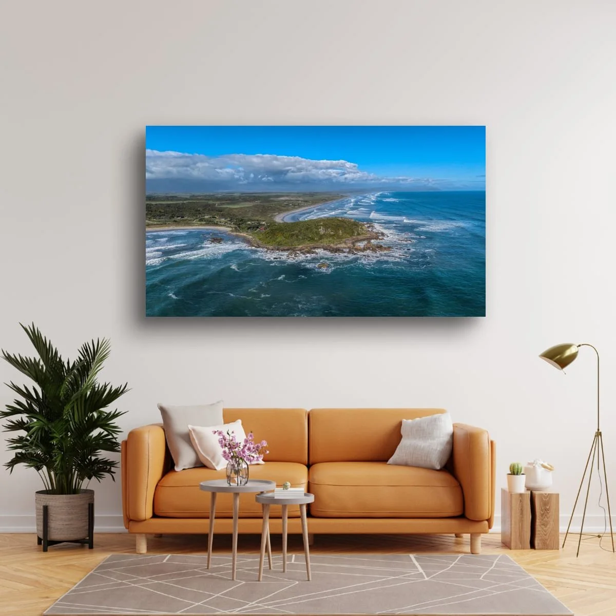 Aerial view of rugged West Coast shoreline and rolling ocean waves.