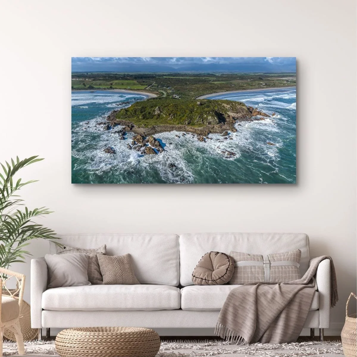 Aerial view of Cape Foulwind surrounded by ocean.