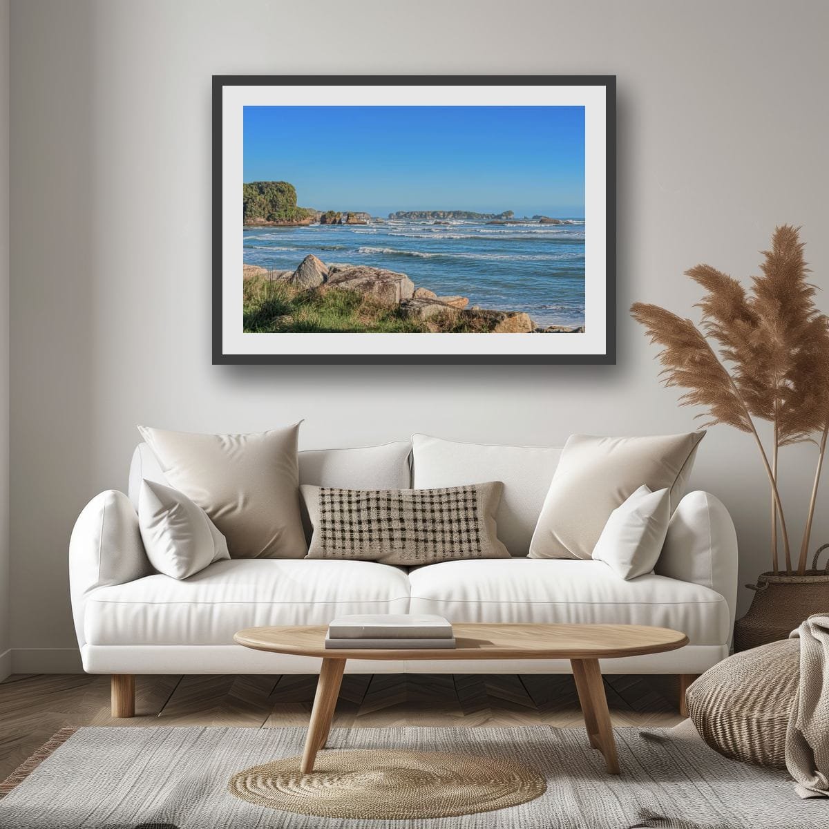 Waves rolling towards rocky coastline beneath blue skies on the West Coast of New Zealand.