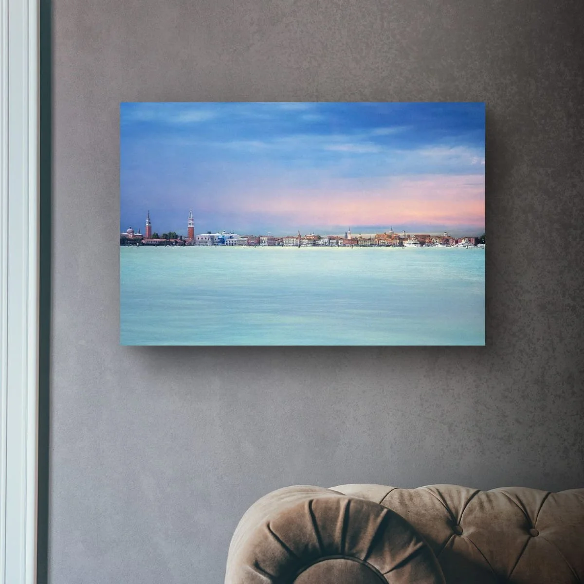 Panoramic view of Venice skyline across calm water beneath pastel skies.