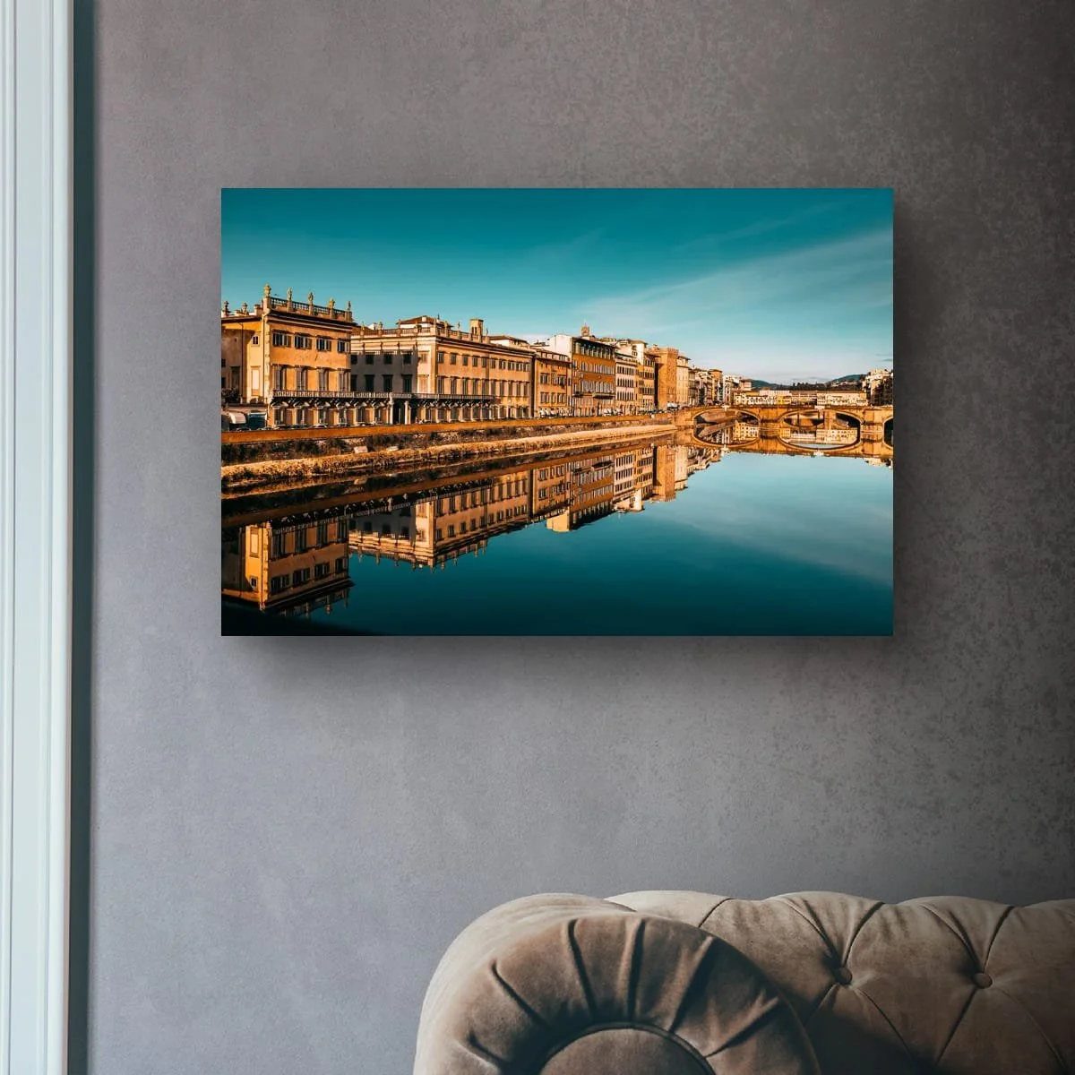 Historic Florence buildings reflected in the Arno River at sunset.