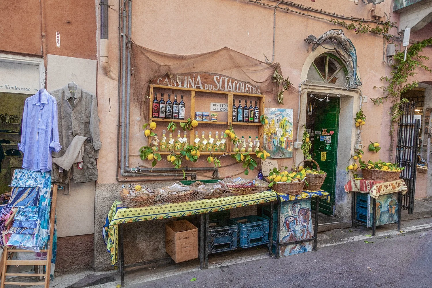 Italian storefront with lemons, wine bottles and rustic village details.