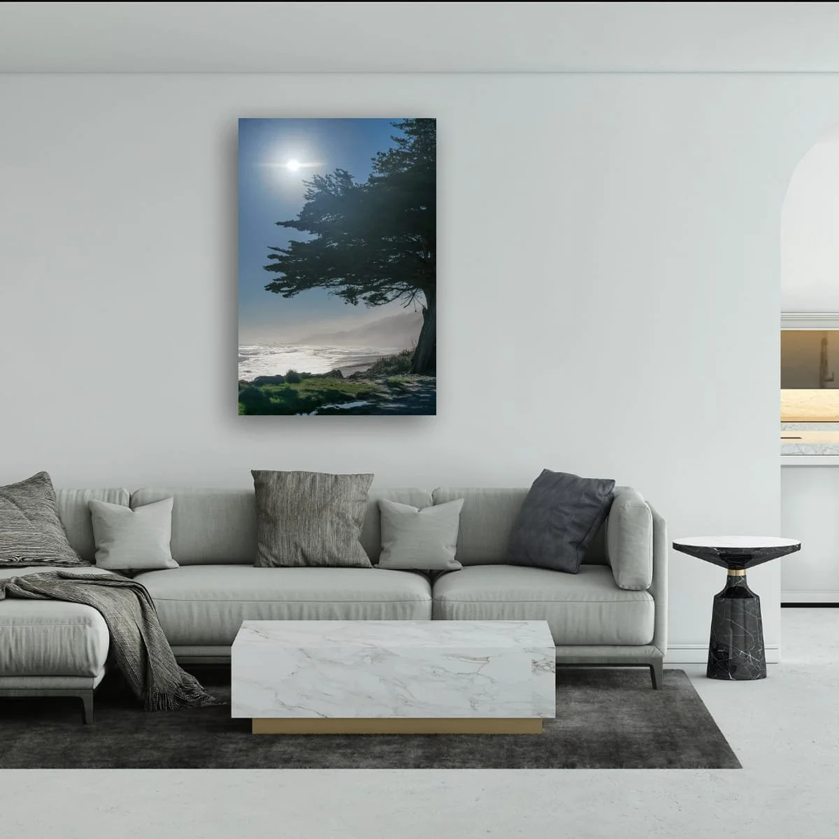 Sunlight shining above a coastal cypress overlooking a misty West Coast shoreline.