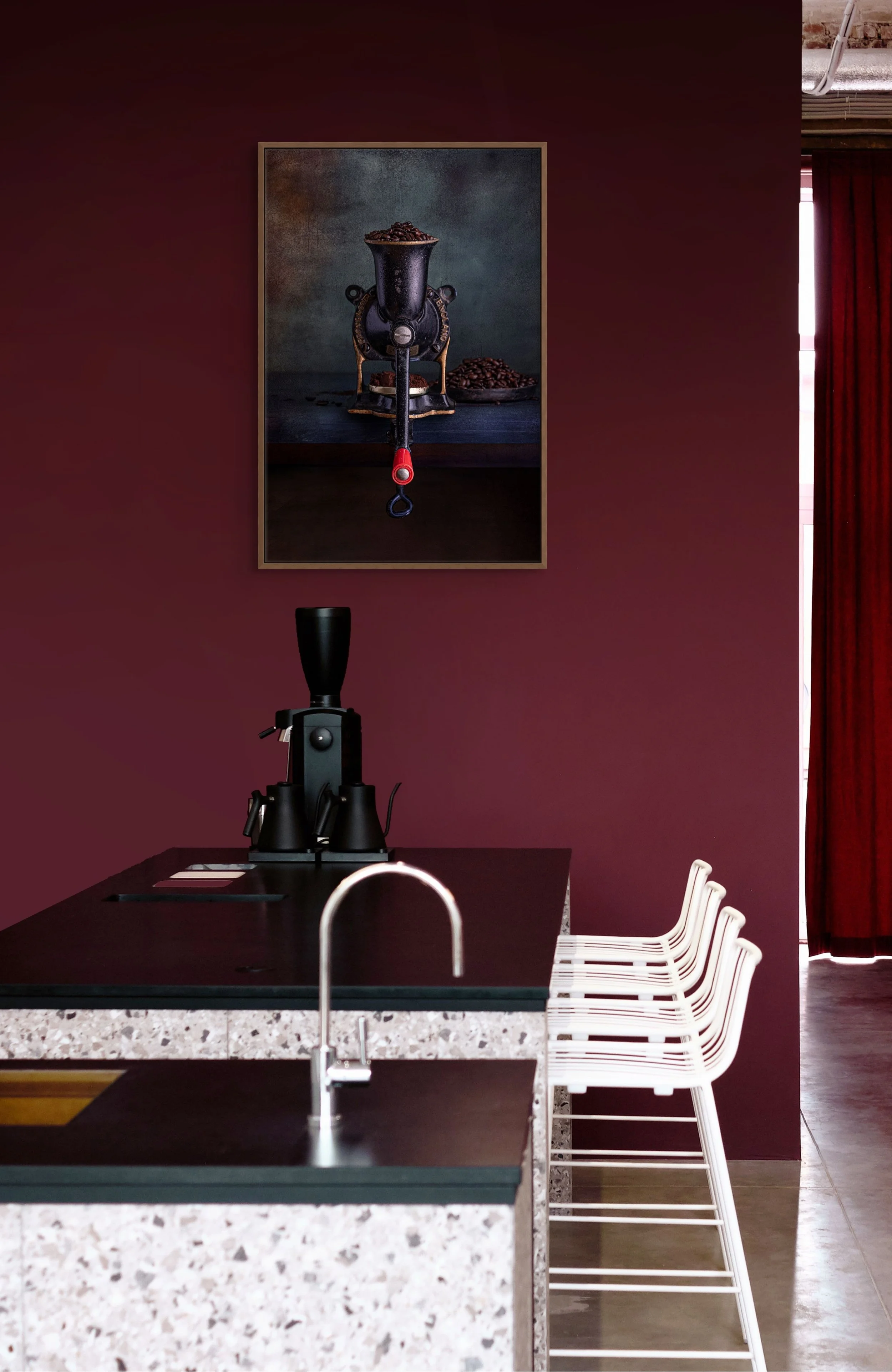 Vintage hand crank coffee grinder filled with coffee beans in still life photography.