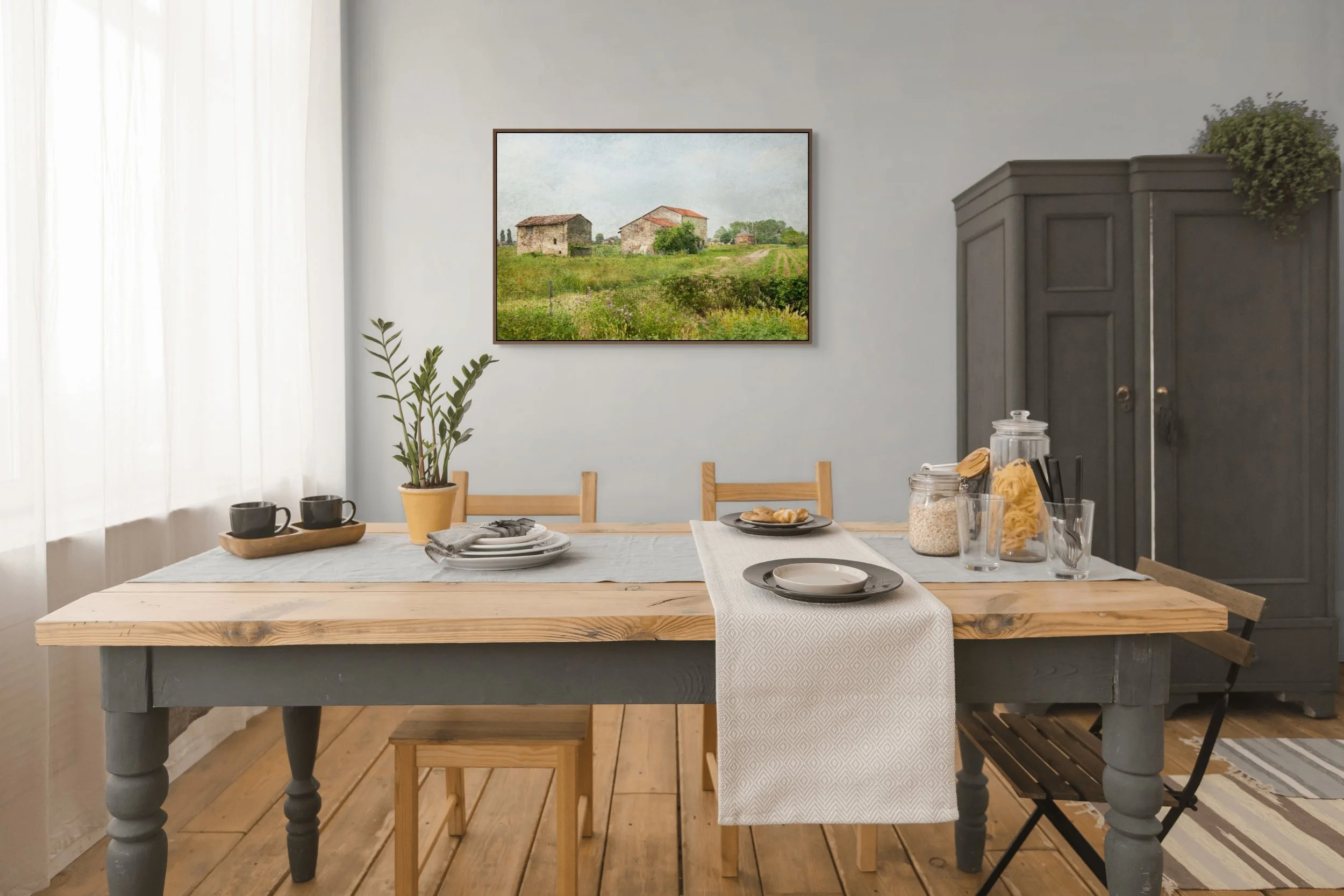 Rustic farmhouses in green countryside fields with winding rural path