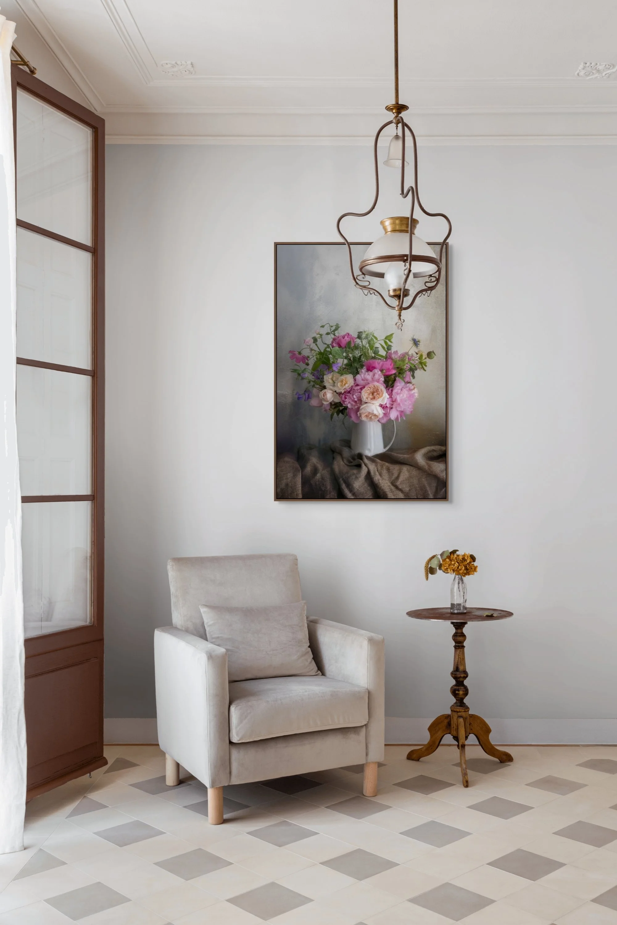 Garden bouquet of peonies and roses arranged in a white jug.
