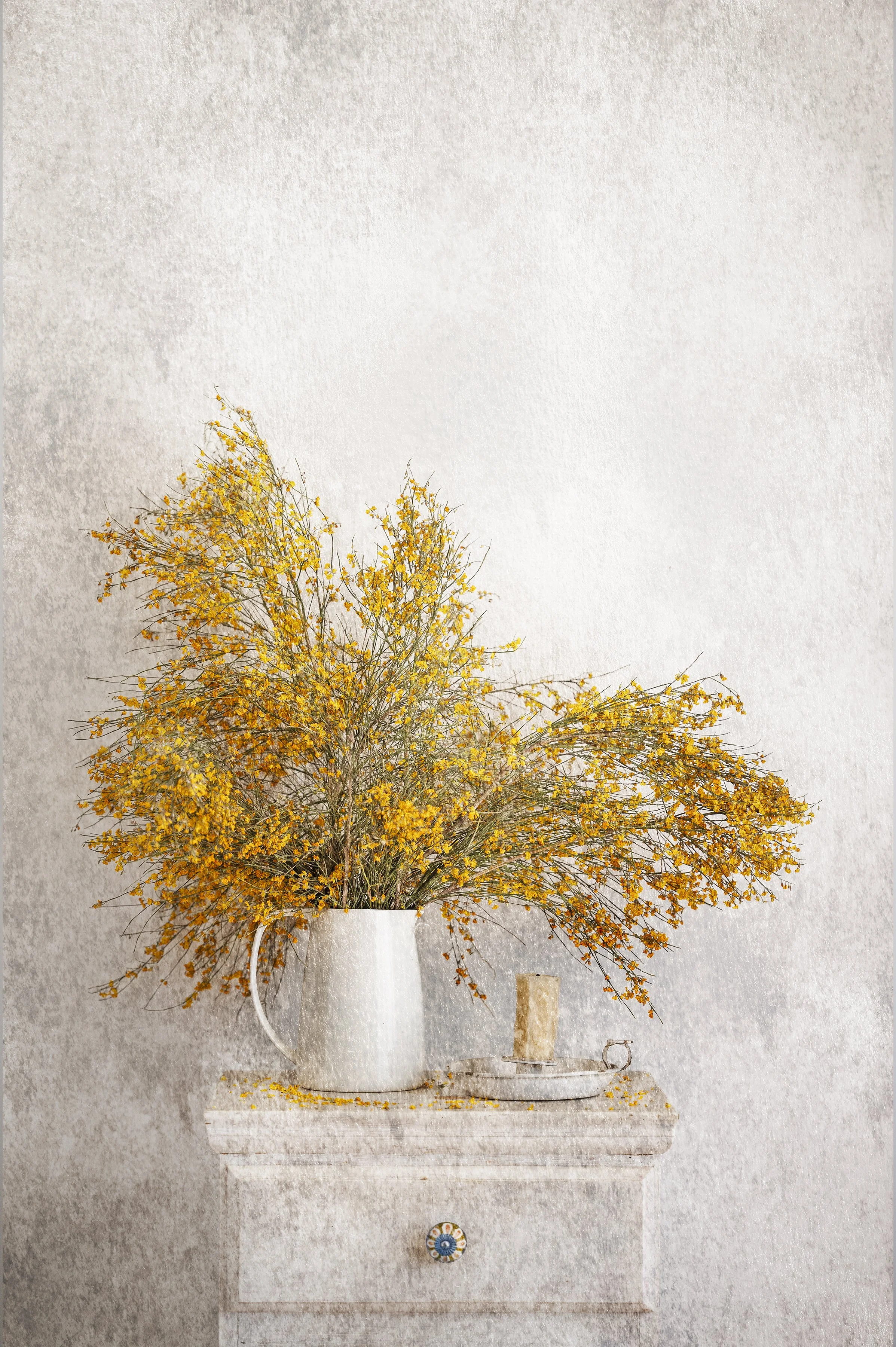 Golden wildflowers arranged in ceramic jug in rustic still life photography.