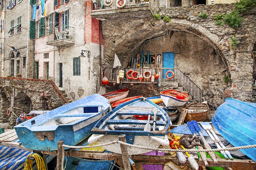 Colourful fishing boats and harbour scene in rustic seaside village.