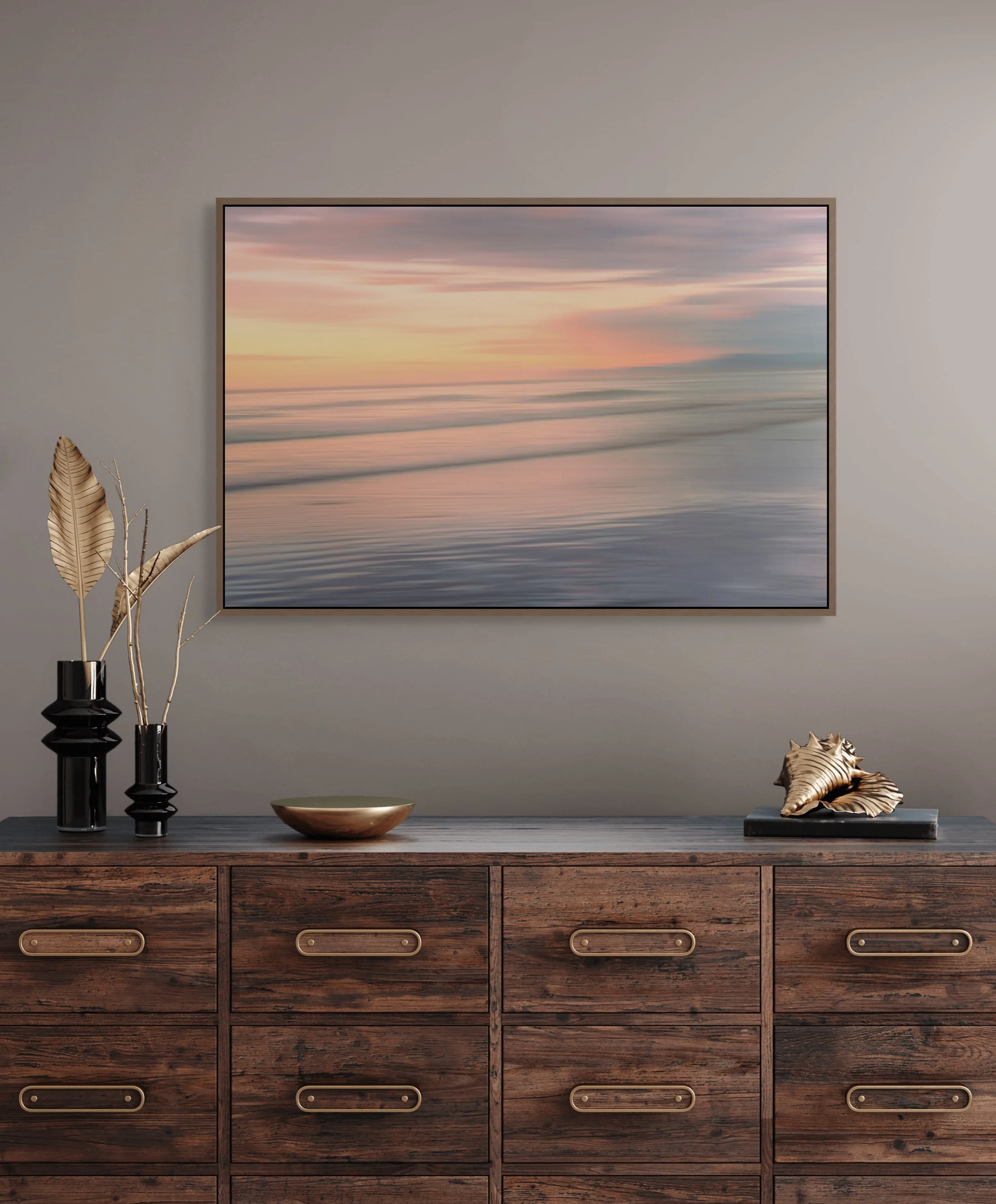 Soft blurred ocean waves at sunset with pink and peach tones.
