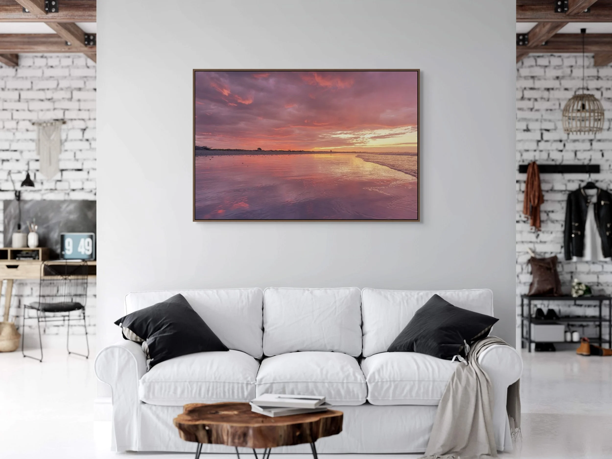 Golden sunset reflecting across calm ocean water and shoreline.