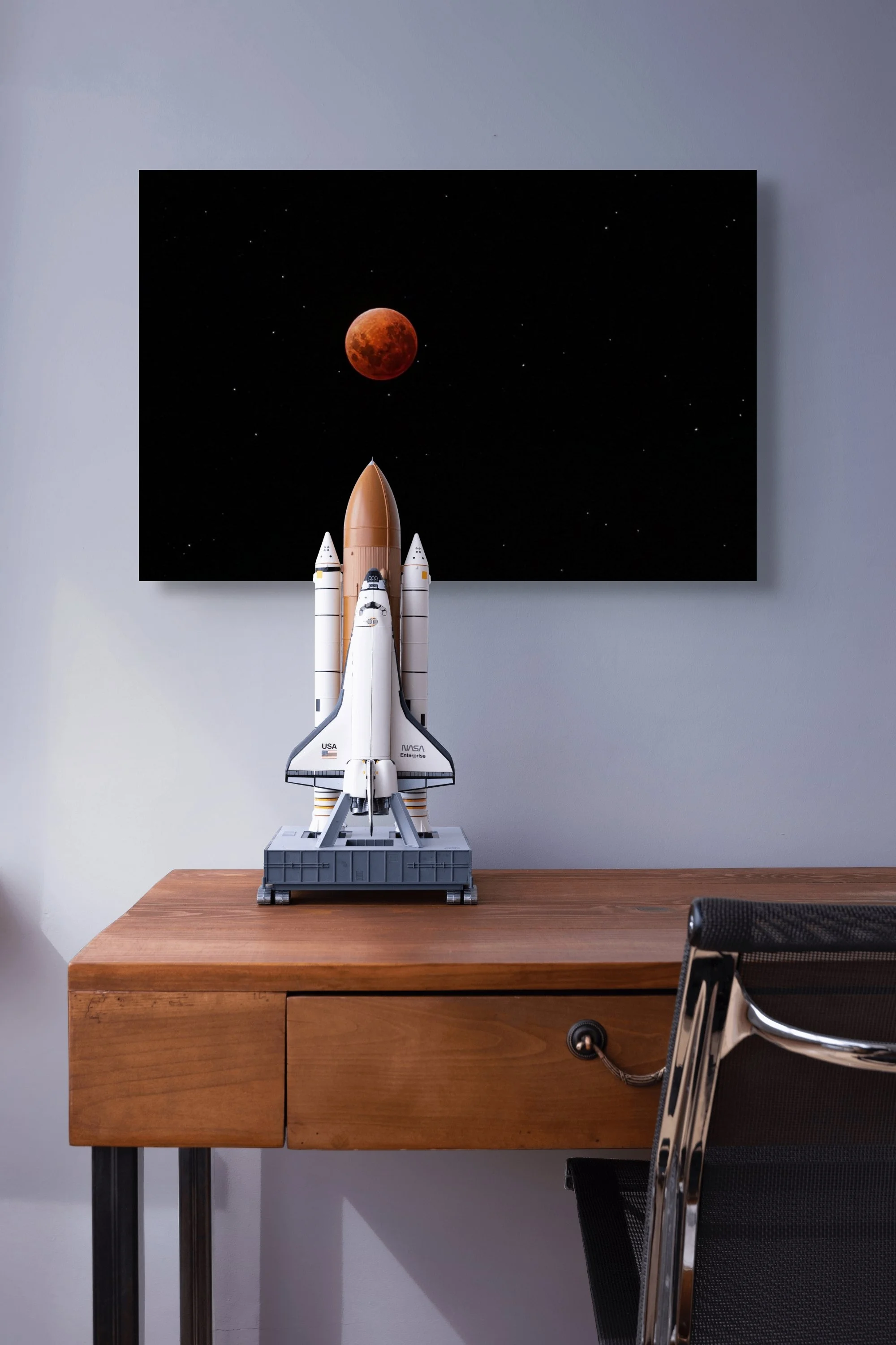 Red blood moon during lunar eclipse surrounded by stars in night sky.