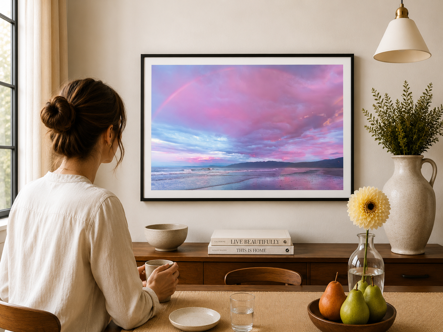 Rainbow above a West Coast beach with pink clouds.