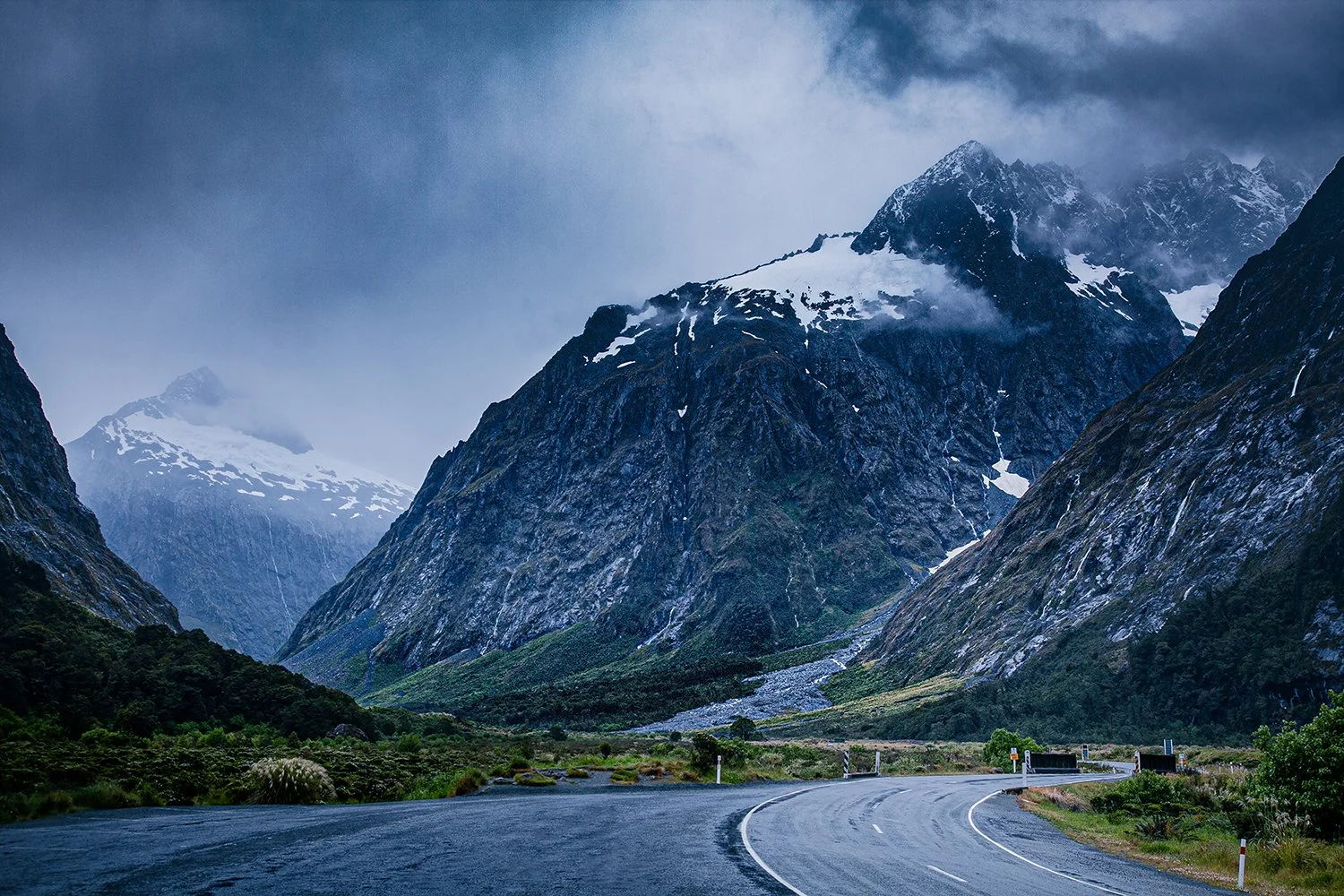 Mountain road winding through Fiordland National Park.