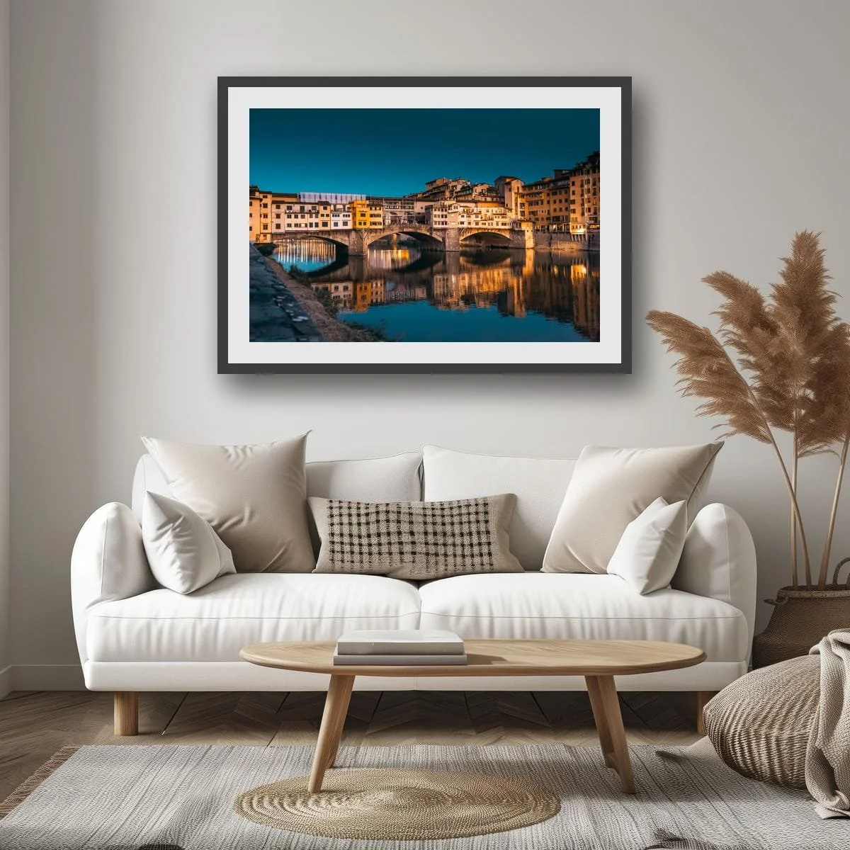 Ponte Vecchio bridge illuminated at dusk with reflections in the Arno River.
