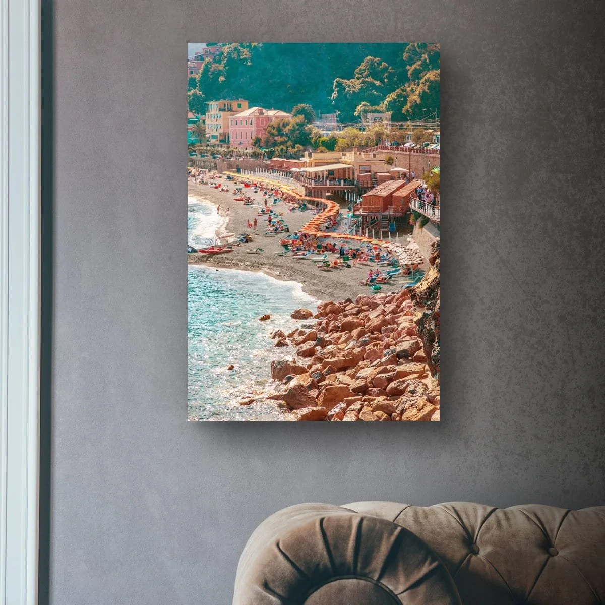 Italian beach scene with umbrellas, people and coastal buildings.