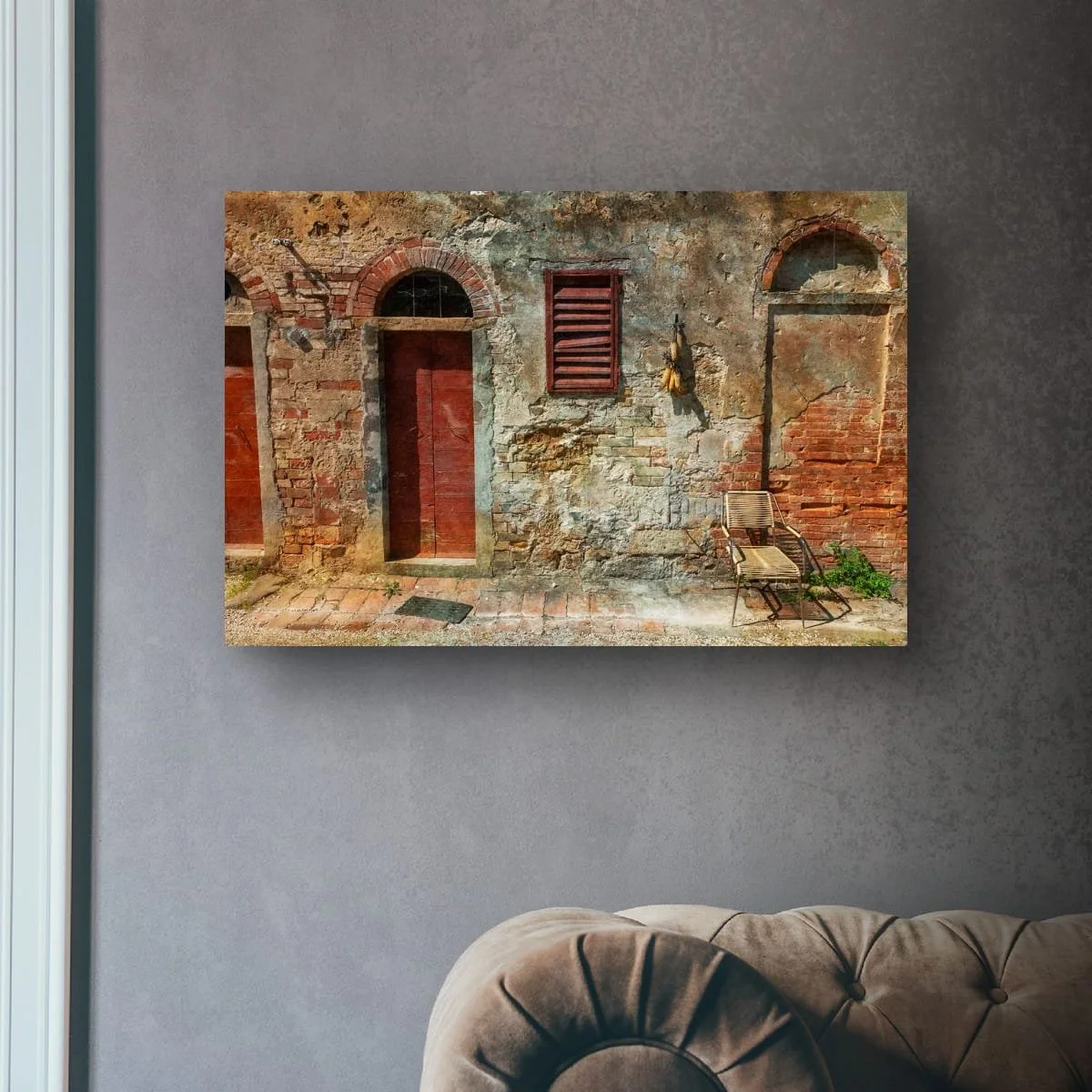 Rustic chair against a weathered Tuscan wall with aged textures.