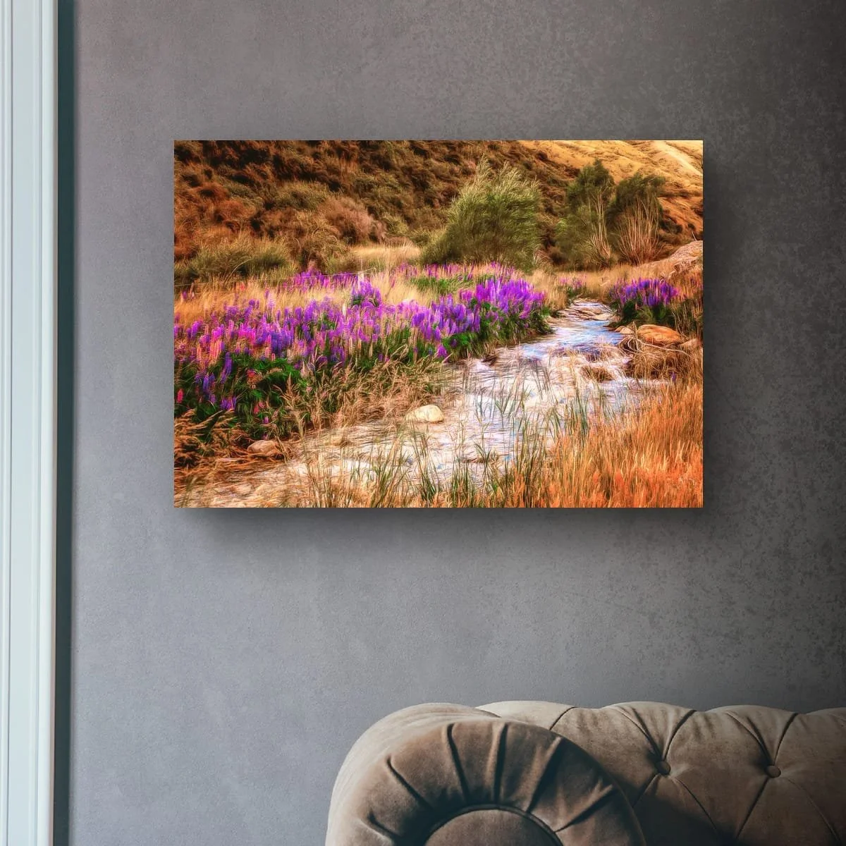 Purple lupins growing beside a winding stream in New Zealand high country.