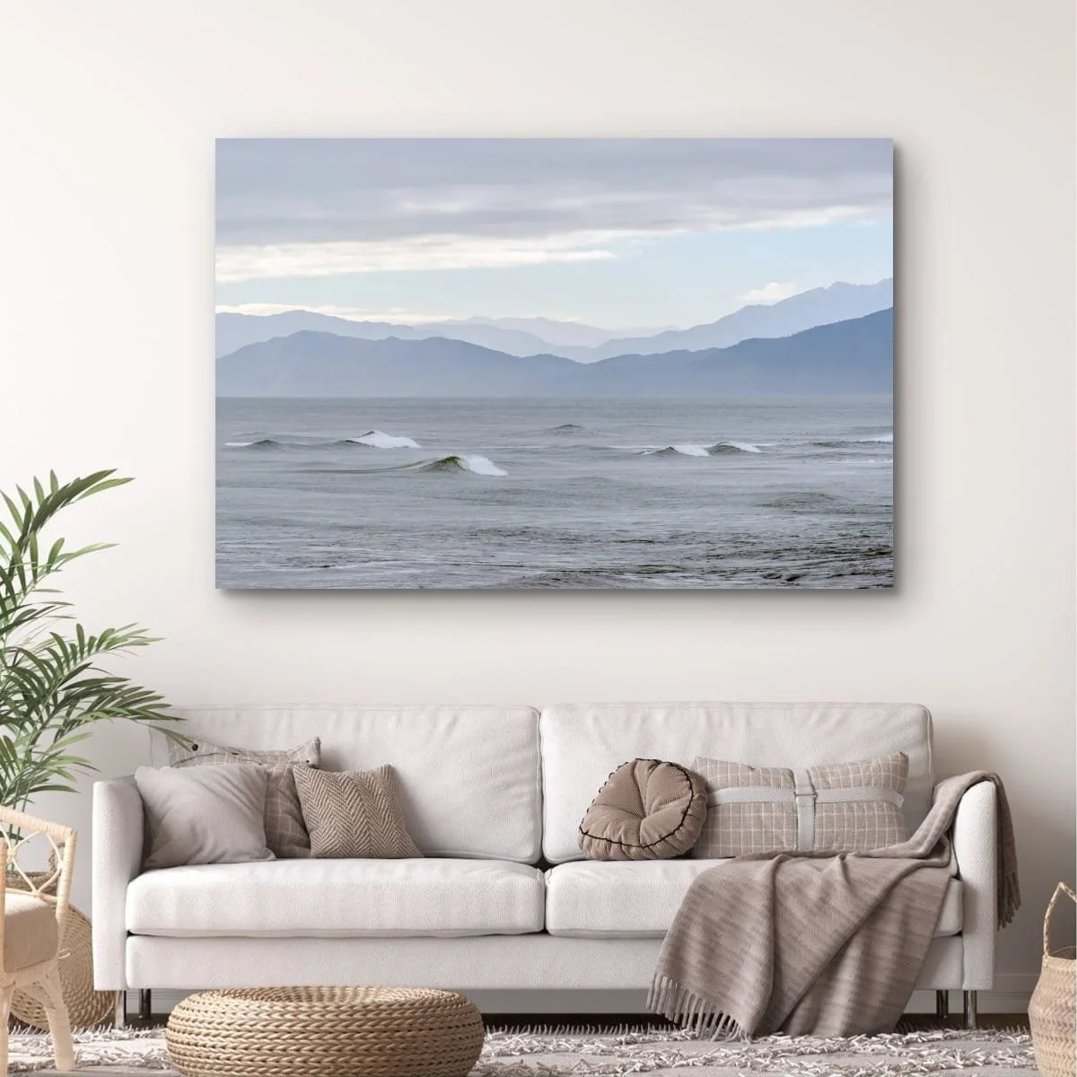 Rolling waves with layered mountain ranges on the West Coast.