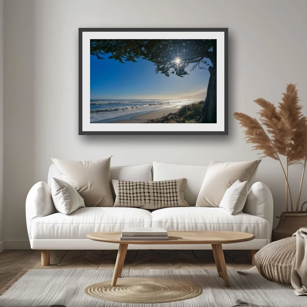 Sun rays shining through coastal tree above a misty West Coast beach.