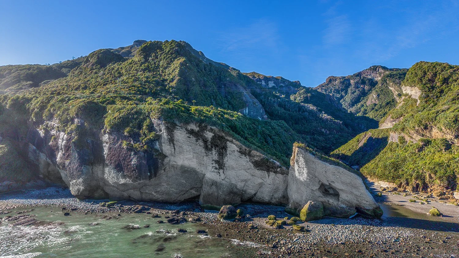 Coastal cliffs and dragon-shaped rock formation near Ten Mile Creek.