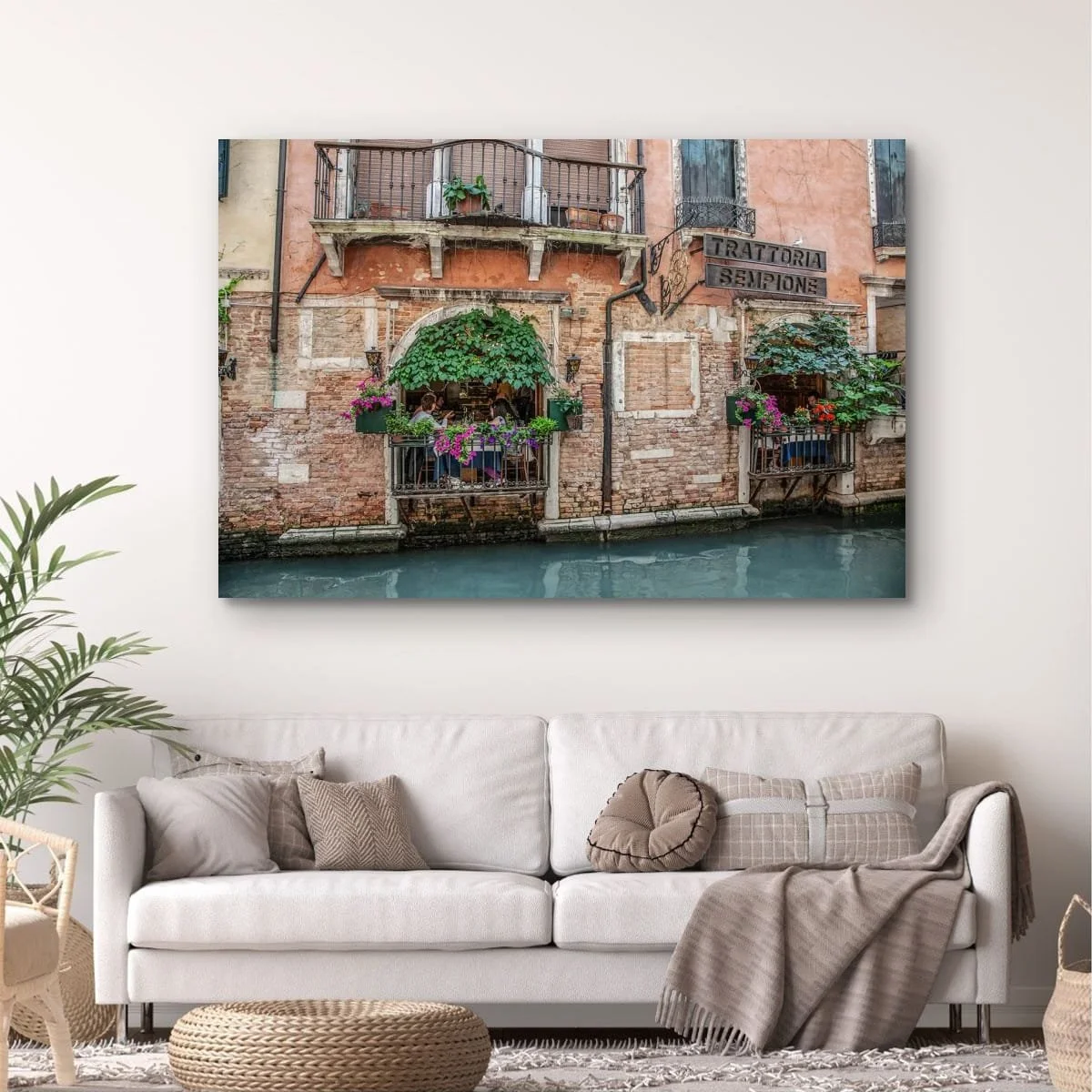 Italian restaurant beside a Venetian canal with flowers and balconies.