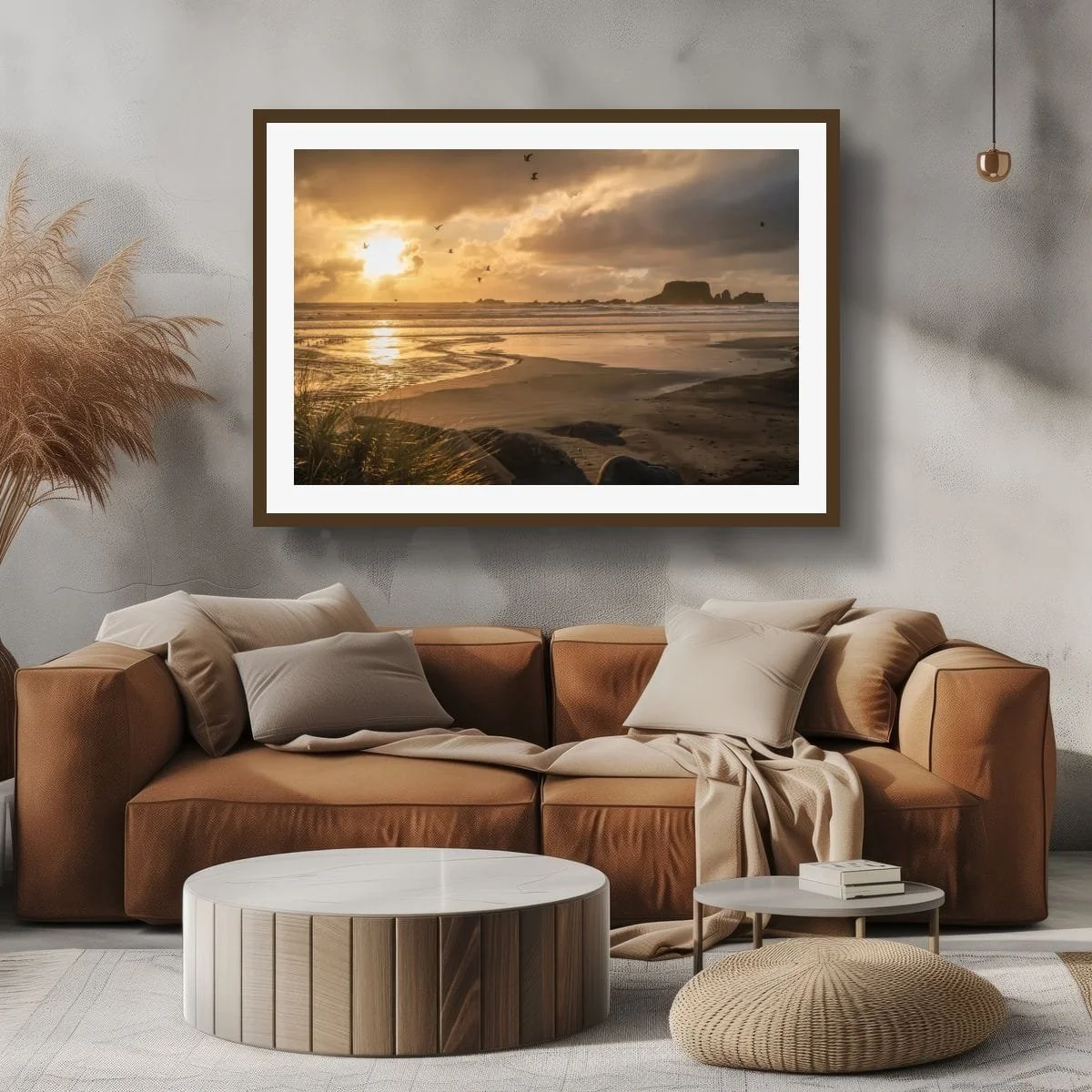 Seabirds flying across a golden sunset above wet sand, ocean waves and distant coastal rock formations.