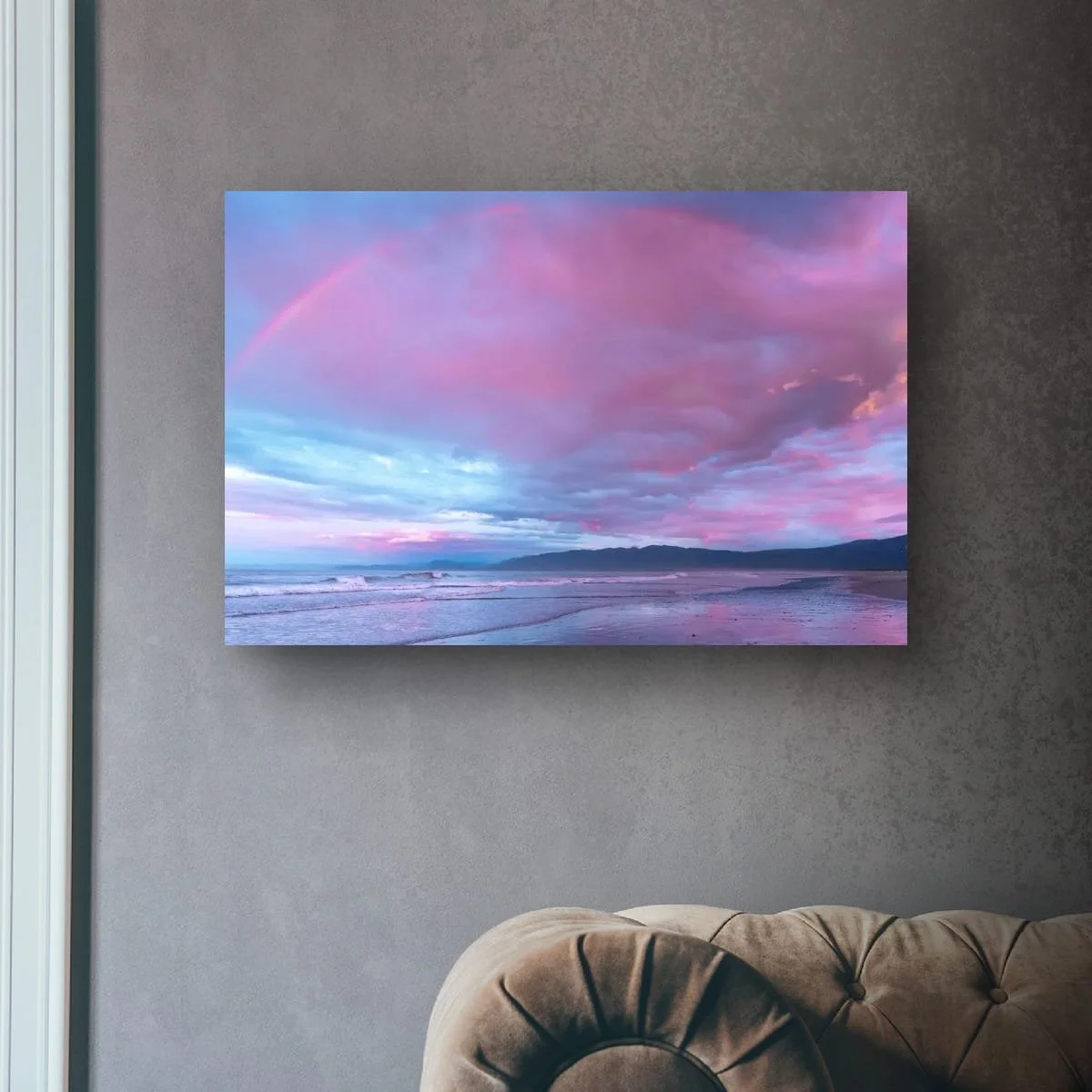 Rainbow above a West Coast beach with pink clouds.